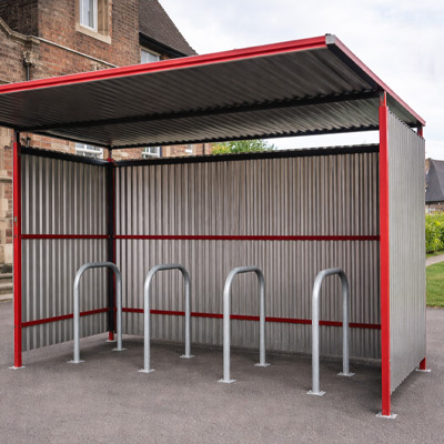 Red Traditional Cycle Shelter closed-back outside a school with Sheffield Hoops
