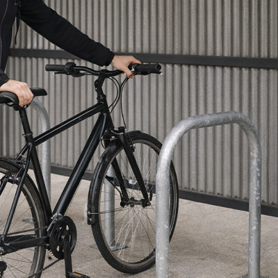 Someone putting bike against Sheffield Cycle Hoops