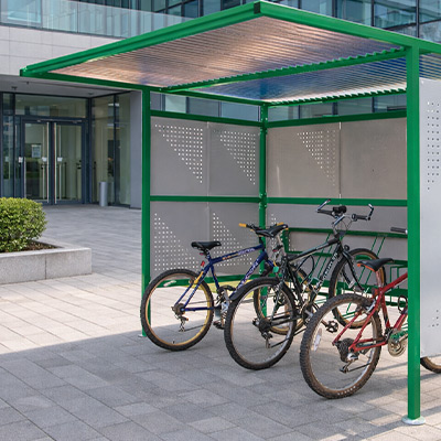 Green Traditional Cycle Shelter with Perforated Sides outside building